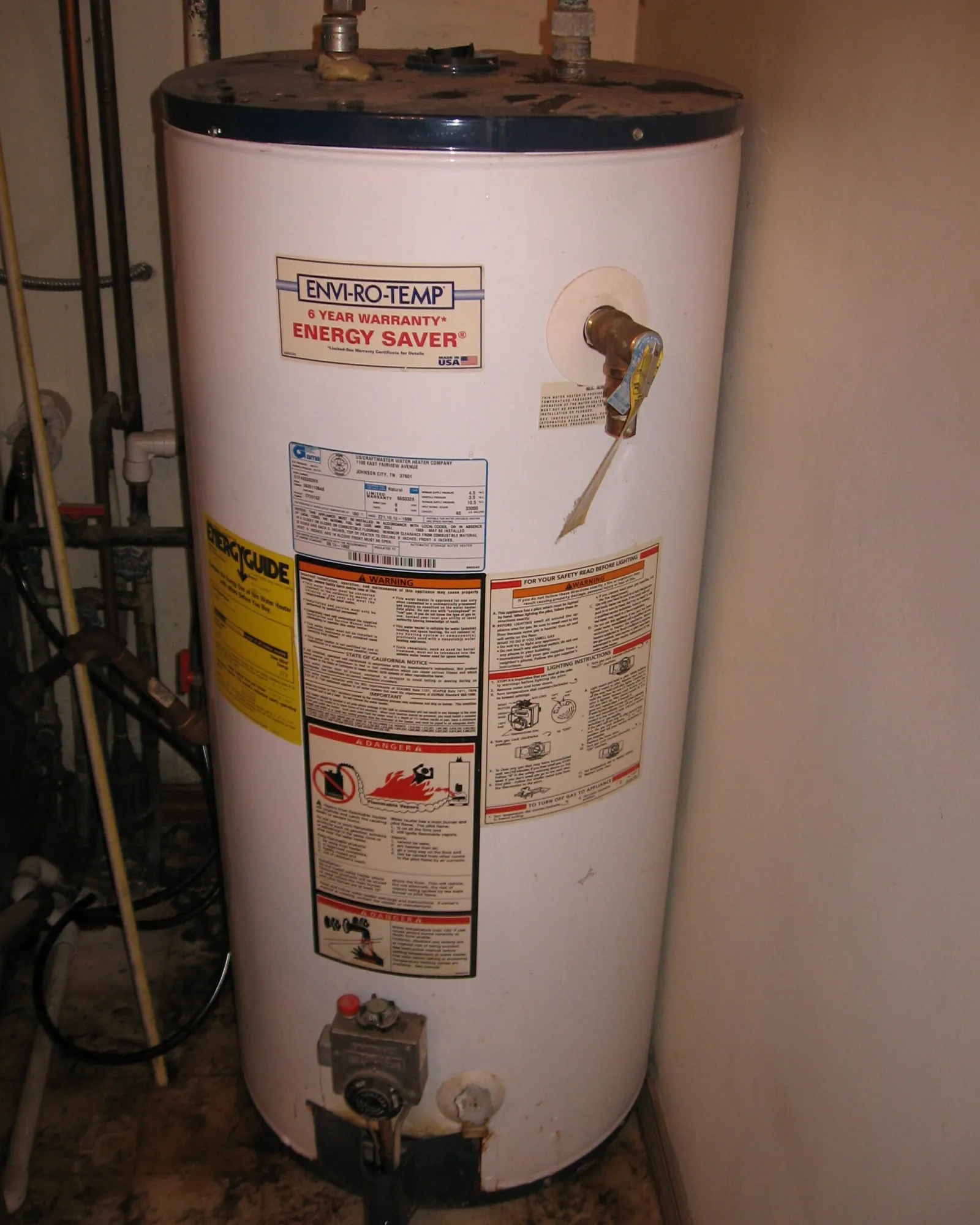 A brass temperature and pressure relief valve attached to a water heater tank.