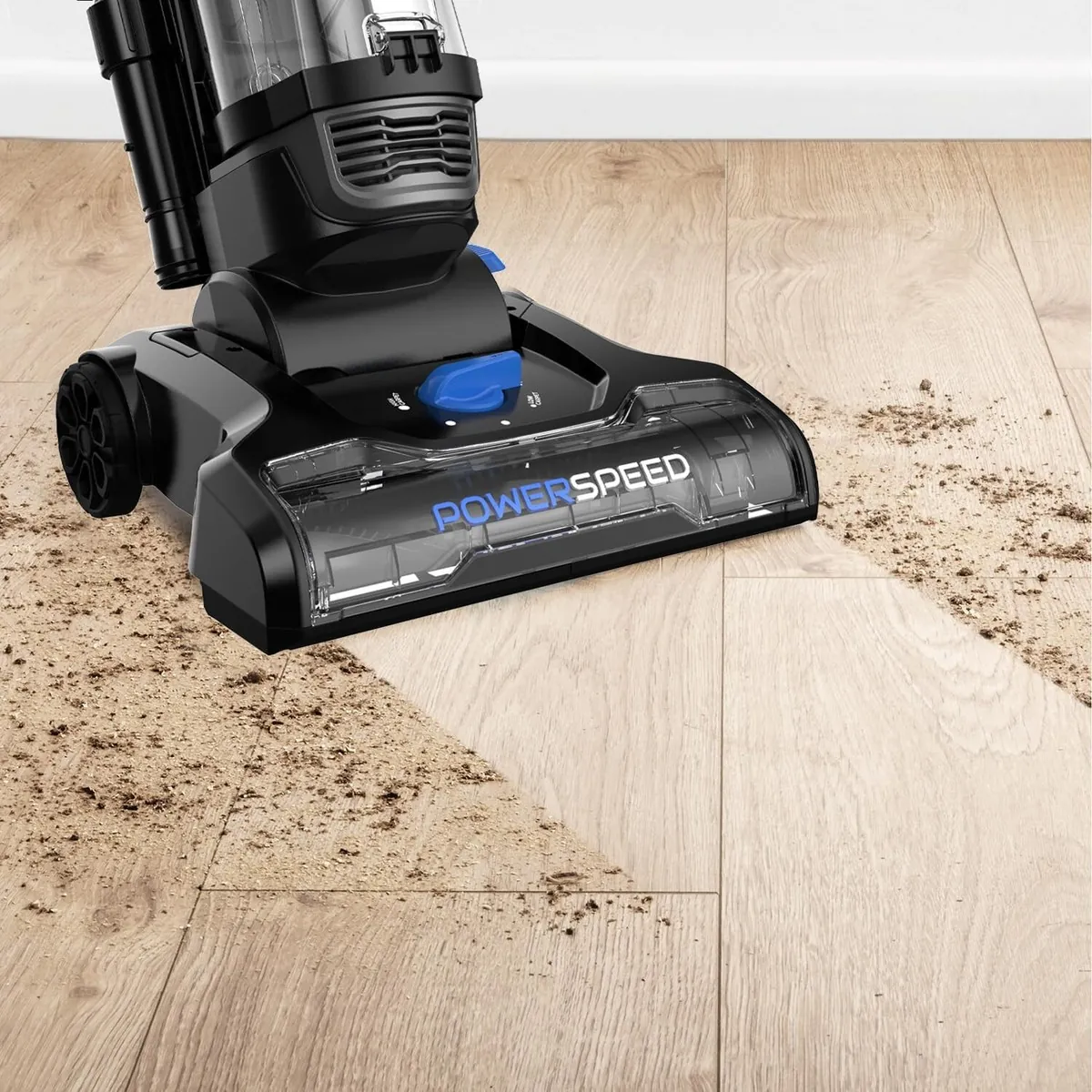 Emptying a vacuum dust cup to maintain consistent suction power and performance.