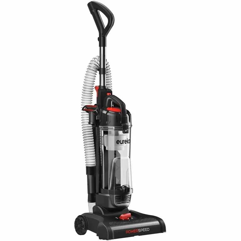 Hands carefully cutting hair and debris from a vacuum cleaner brush roll.