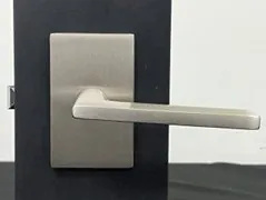 Hands replacing batteries in an emtek emtouch lock to ensure proper power supply.