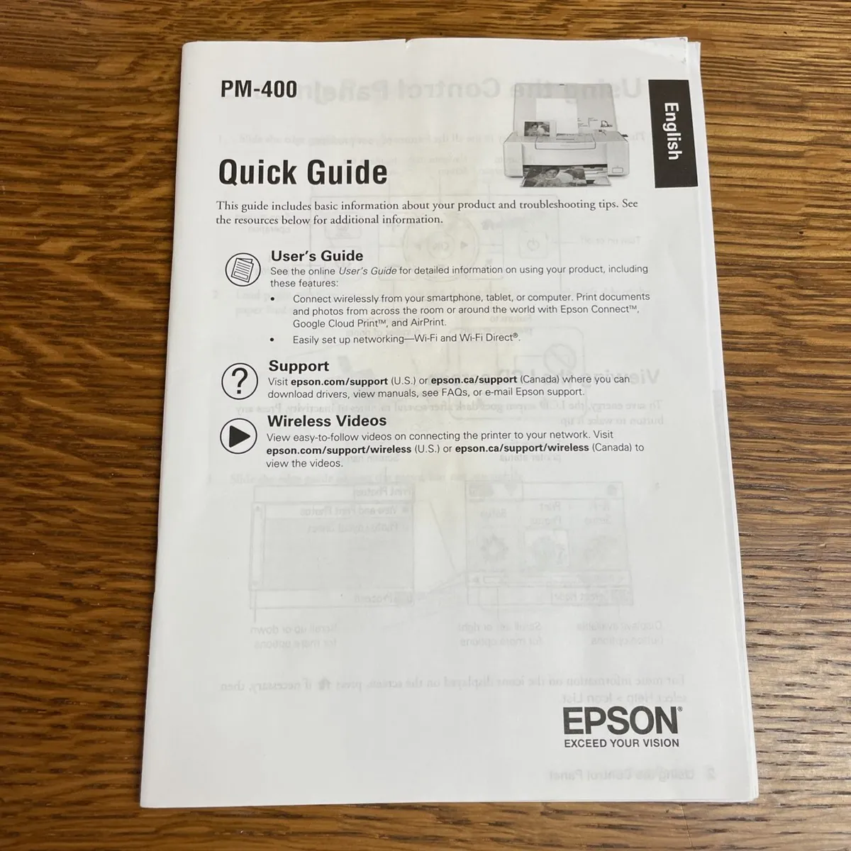 Loading genuine photo paper into the Epson printer feed tray.
