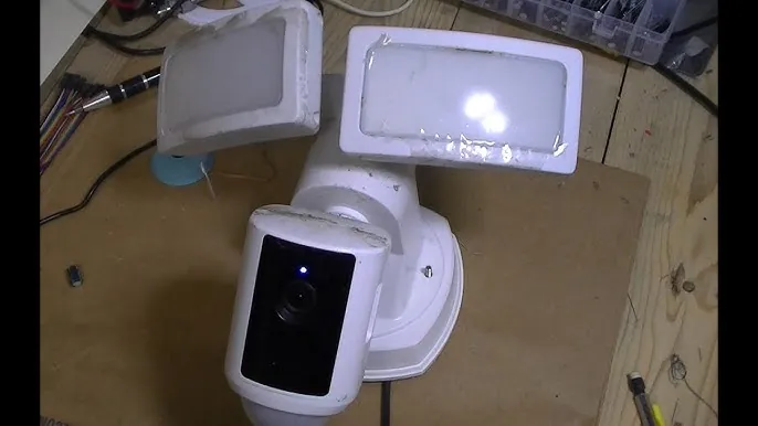 A modern wireless router provides a signal to a distant outdoor security camera.