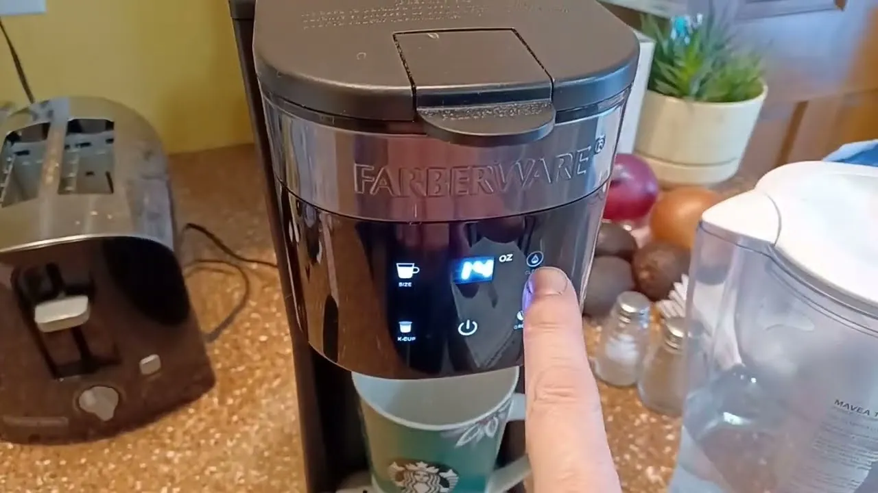 A person inspects the pod holder inside a single serve coffee maker.