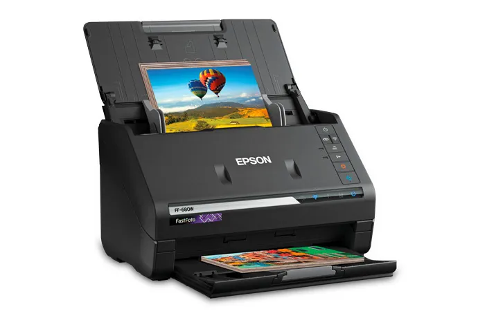 A person updating scanner software on a laptop to resolve Epson driver issues.