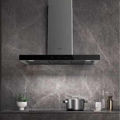 Removing a grease-saturated metal mesh filter from a kitchen range hood for cleaning.