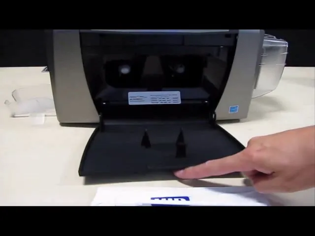 A user manages print driver settings on a laptop to fix a Fargo DTC1250e printer.