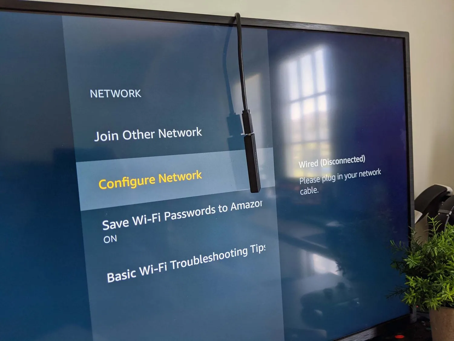 Checking the HDMI connection on a Firestick to resolve no signal errors.