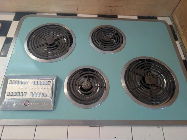 Close-up of damaged electric stove burner prongs showing signs of electrical wear.