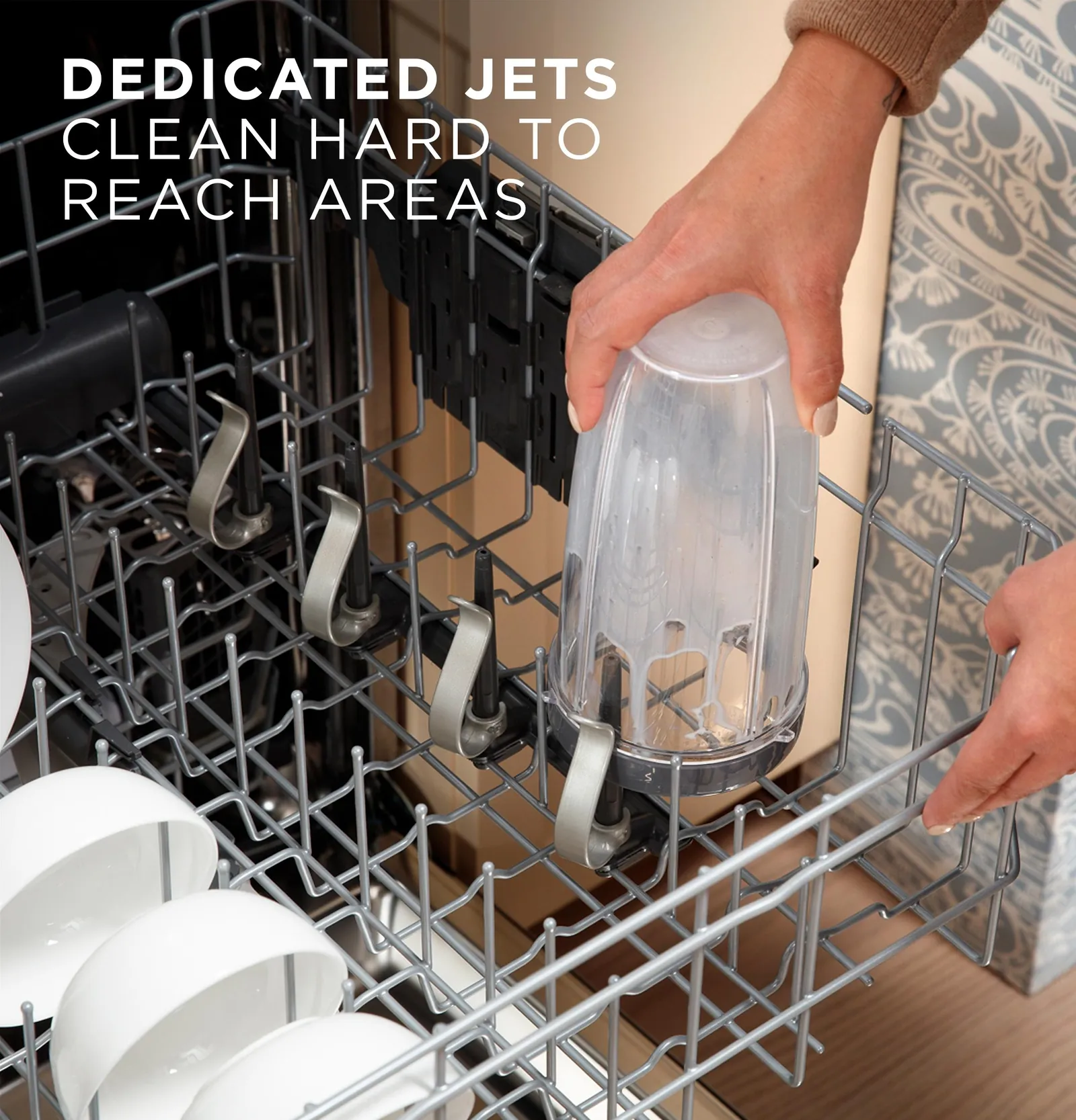 Close-up of a hand closing a dishwasher door to troubleshoot a latch issue.