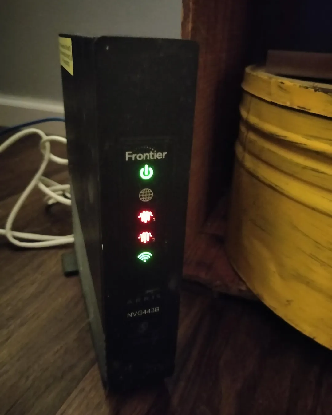 A damaged ethernet cable plugged into a wall jack indicating potential signal loss.