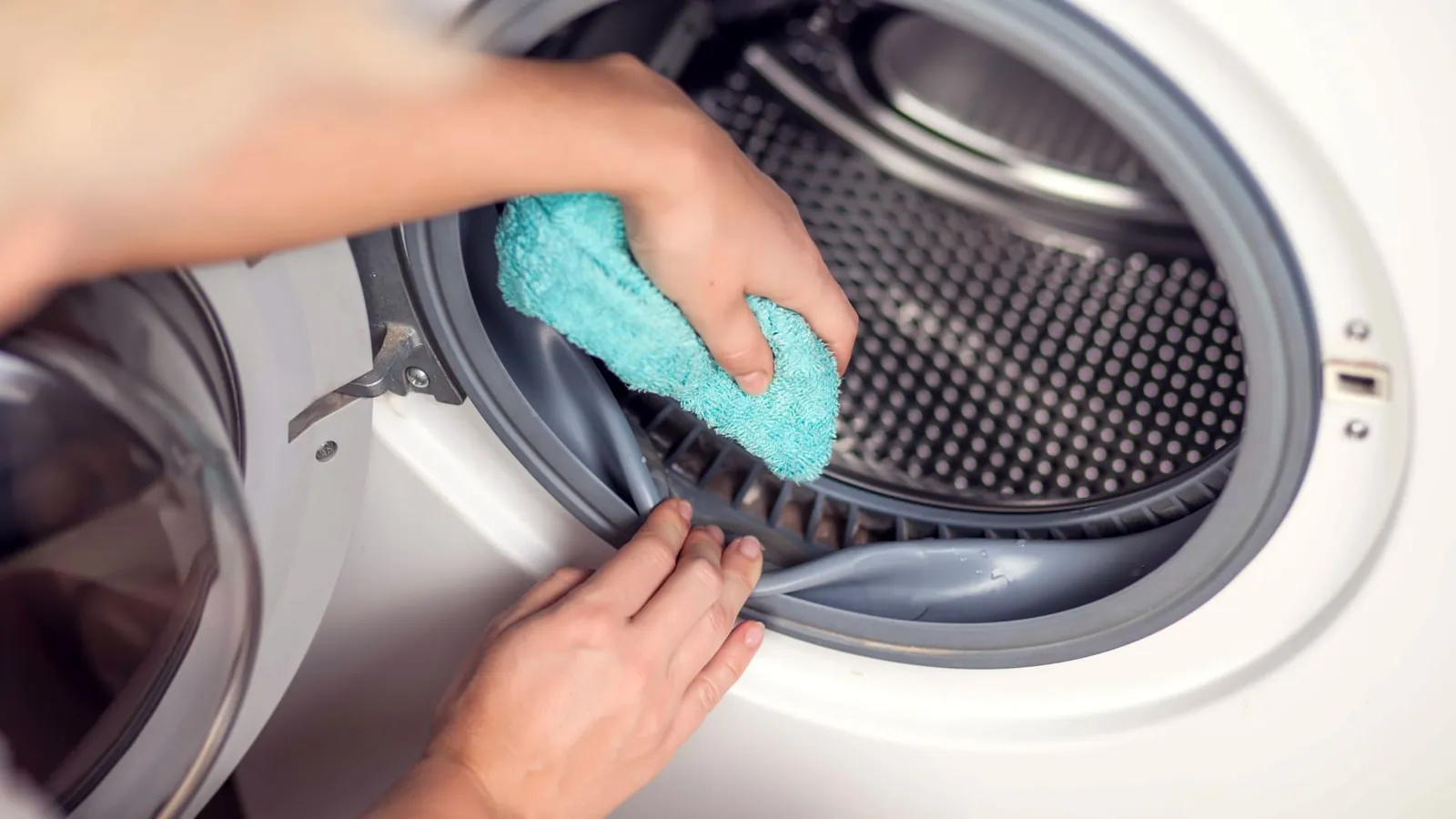 A dirty dishwasher filter is held for inspection during GE appliance troubleshooting tasks.