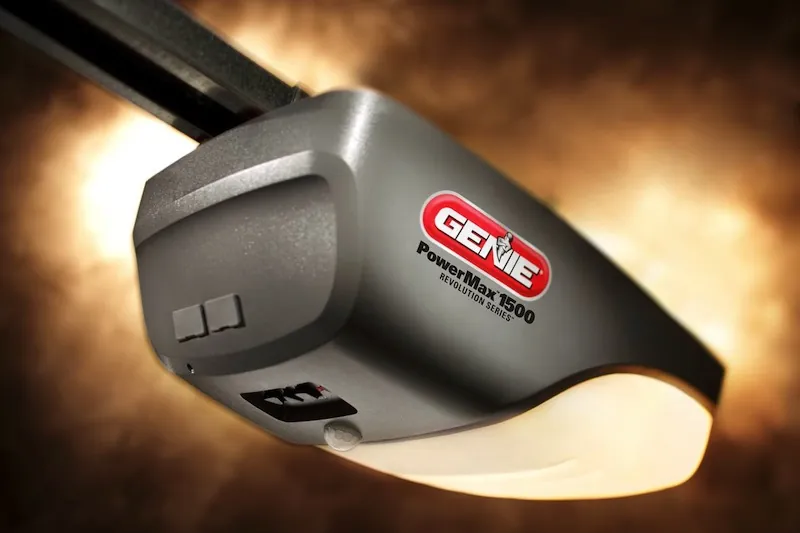 Hand pressing the learn button on a garage door opener to sync remote controls.