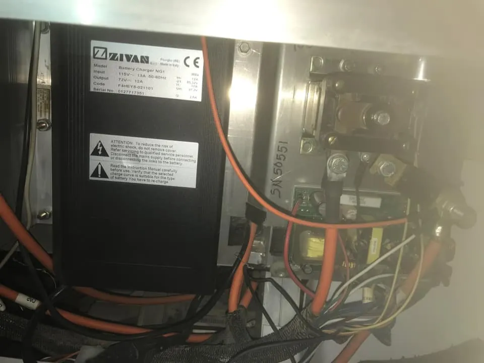 A loose electrical cable connection inside a low-speed vehicle chassis.
