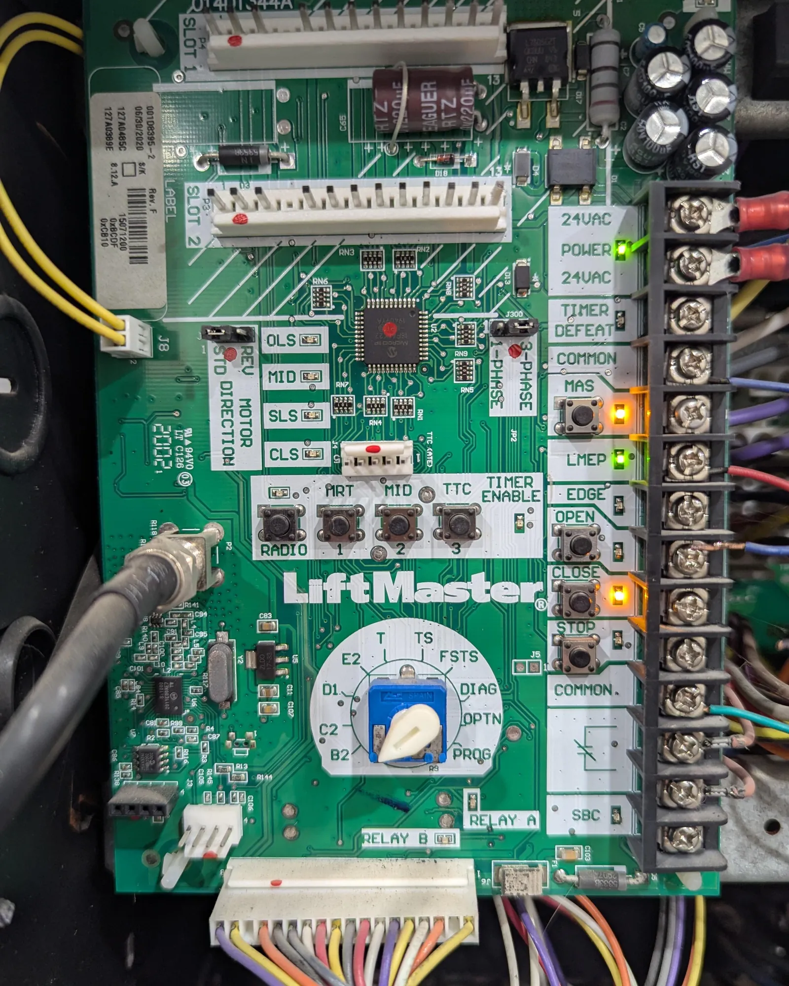 Misaligned infrared safety sensors on a garage door track causing opener failure.