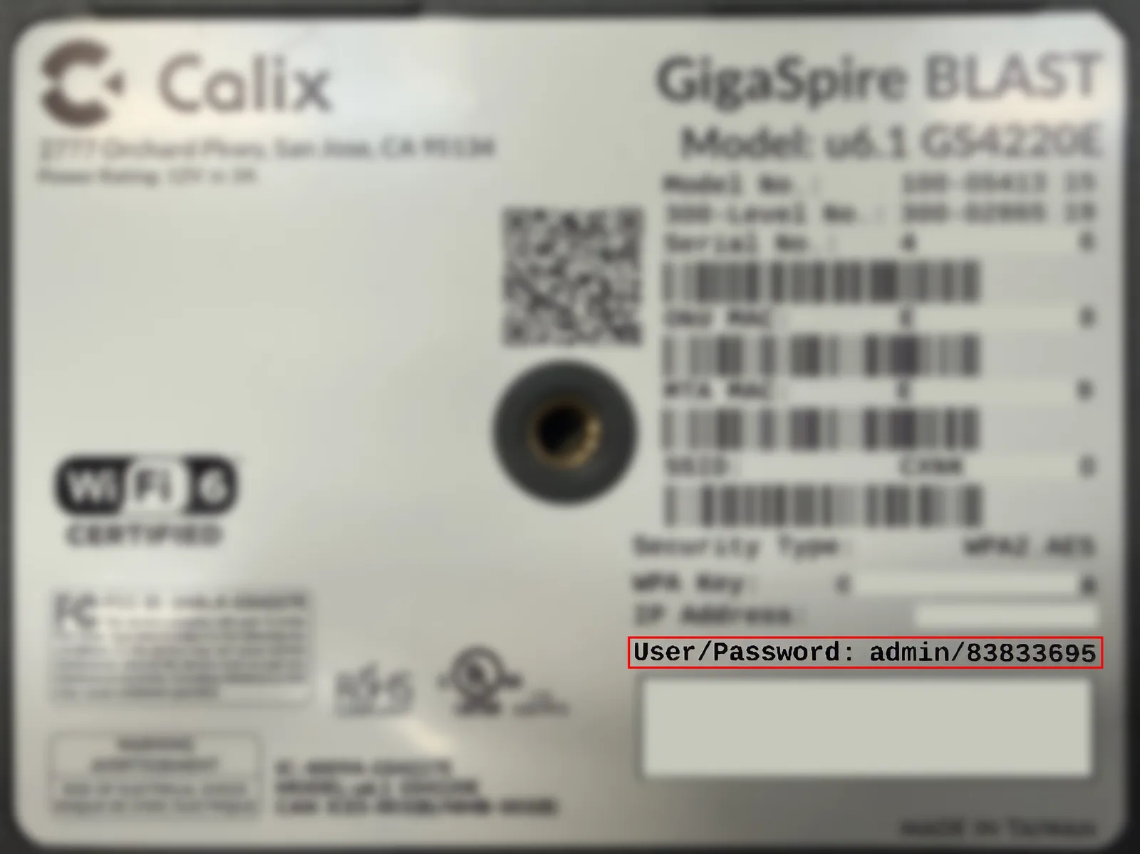 A person checking the Ethernet cable connection on the back of a GigaSpire GS4220e router.