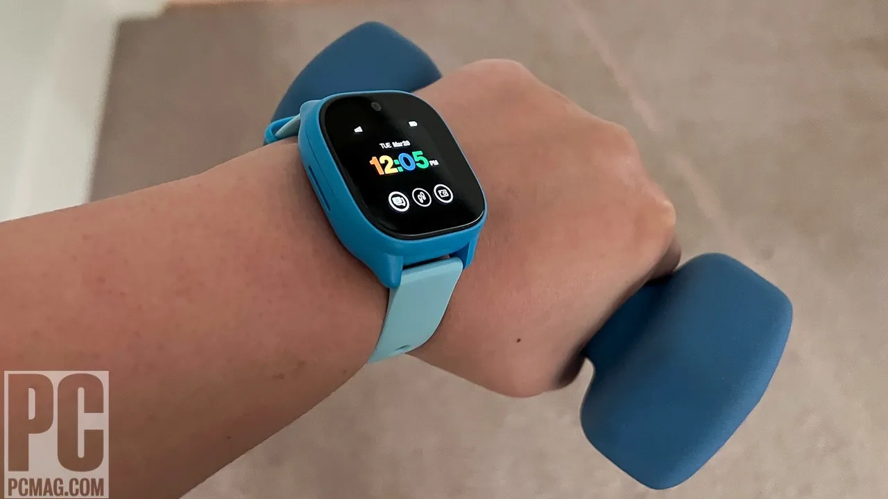 A smartwatch charging on a wooden table to resolve power issues.