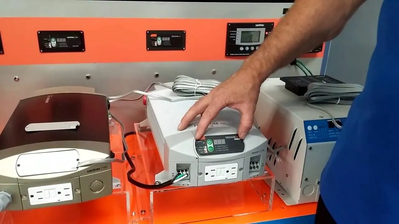 A technician checking battery terminal voltage for a Freedom HF 1500 inverter system.
