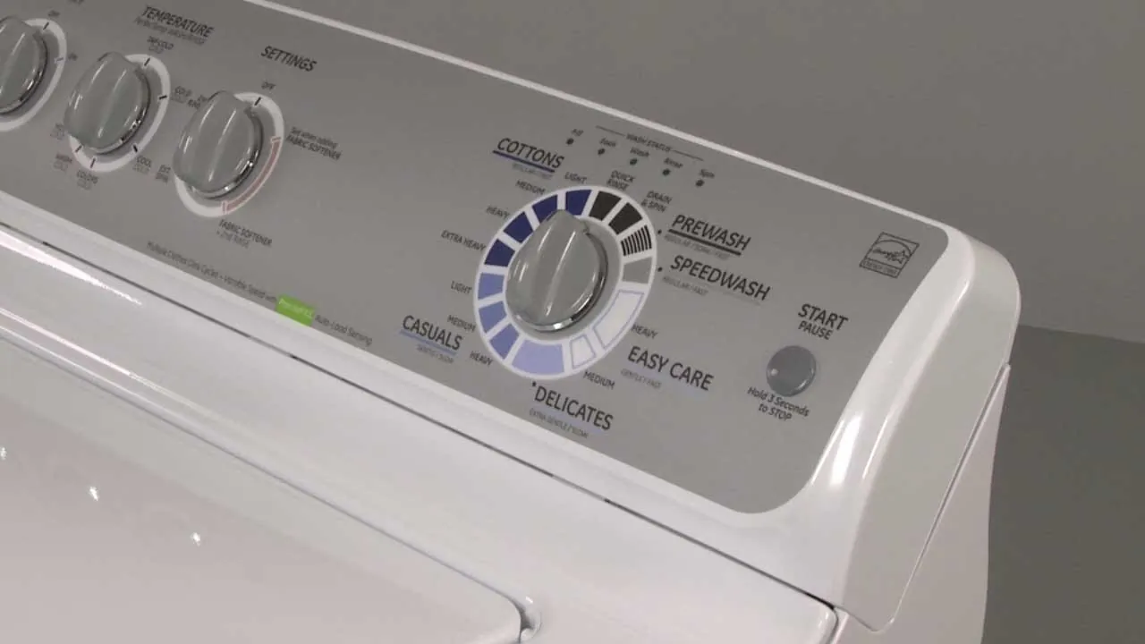 A technician checking the lid sensor on a GE top loading washing machine.