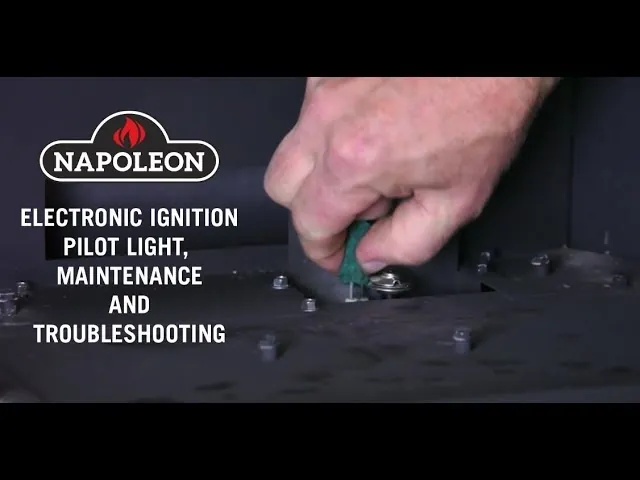 A technician testing the electronic ignition battery terminals inside a gas fireplace system.